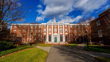 A formal red brick building on a college campus.