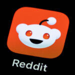 The Reddit application can be seen on the display of a smartphone.