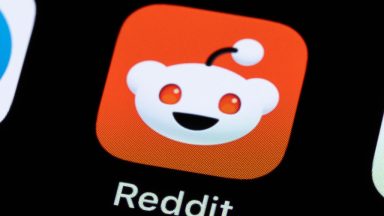 The Reddit application can be seen on the display of a smartphone.