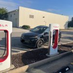 Bolt awkwardly parked sideways behind some Tesla stations