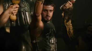 Roman gladiator raising a cup to toast his fellow fighters