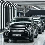 A line of electric vehicles of the model Y is pictured during the start of the production at Tesla's "Gigafactory" on March 22, 2022 in Gruenheide, southeast of Berlin