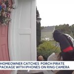 Footage from a doorbell camera shows a man in a hooded sweatshirt, with his face turned away, grabbing a shipment box from a doorstep.