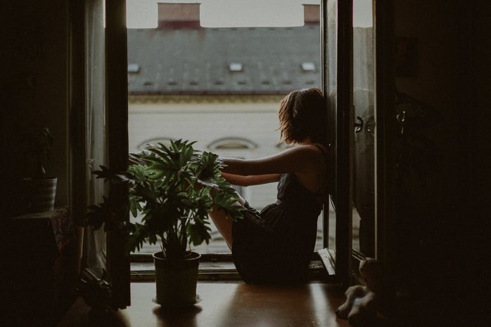 woman leaning on door looking out onto the city by Kinga Cichewicz?width=698&height=466&fit=crop&auto=webp