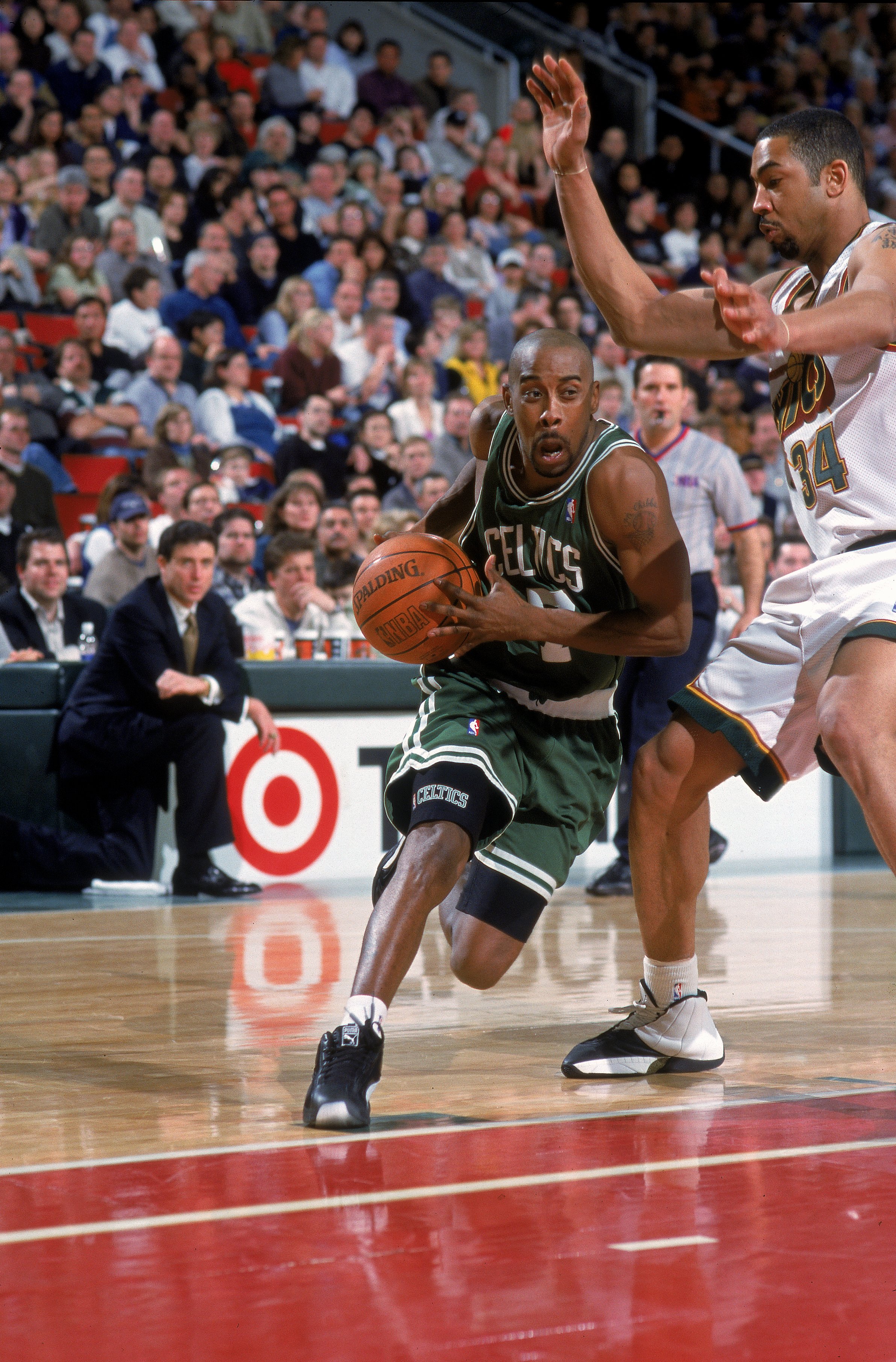 19 Feb 2000: Kenny Anderson #7 of the Boston Celtics moves with the ball around Jelani McCoy #34 of the Seattle SuperSoncis during the game at the Key Arena in Seattle, Washington. The Sonics defeated the Celtics 94-91..