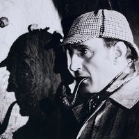 British actor Basil Rathbone, as Detective Sherlock Holmes who he portrayed in several movies based on the detective created by Arthur Conan Doyle.