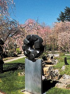 “Black Sun,” black tamba granite sculpture by Isamu Noguchi, 1960–63; in a private garden