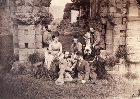 Before the Chapter House at Wenlock [Abbey, England]. 1873