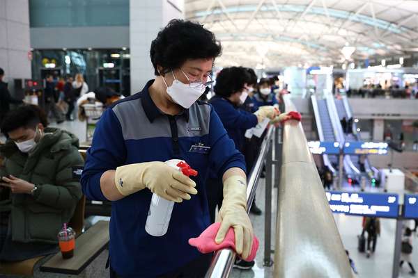 Coronavirus - Disinfection workers wearing masks spray anti-septic solution at the Incheon International Airport on January 27, 2020 in Incheon, South Korea. COVID-19 Epidemic pandemic