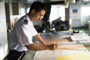 officer using charts for navigation