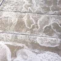 winter ice melting salt on the ground, pattern as background