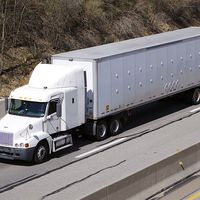 White semi truck on the Highway. Truck, lorry, motor vehicle to carry freight or goods or perform special services. Cab, carrier, semis trucks.