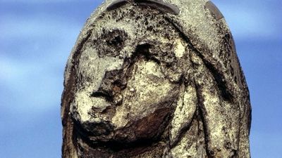 Statue eroded by acid rain, pollution, weathering.