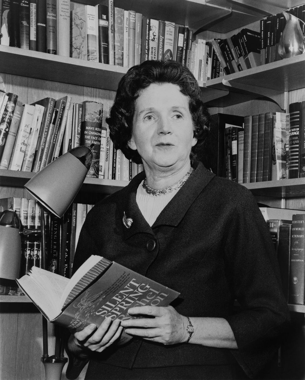 Rachel Carson holding a copy of her book "Silent Spring" in 1963. Biologist writer. (environment, pollution)