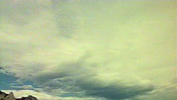 View a time-lapse video of cloud formations rolling across the sky followed by a thunderstorm