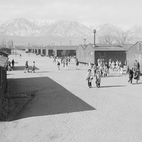 High school recess period, Manzanar Relocation Center (internment camp, Japanese-Americans), near Lone Pine, California. Photograph by Ansel Adams, 1943.