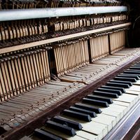 Old broken disused piano with damaged keys