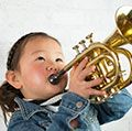 Young girl wearing a demin jacket playing the trumpet (child, musical instruments, Asian ethnicity)