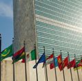 Secretariat Building at United Nations Headquarters with Members States' flags flying in the foreground, United Nations Headquarters, New York City, New York. (photo dated 2017)