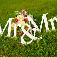 Sign for wedding "Mr & Mrs" (mister and missis) with flowers in the grass