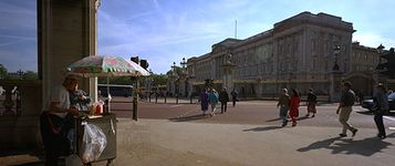 Buckingham Palace, London, from the intersection of Constitution Hill and the Mall. The east facade of the palace was designed by Sir Aston Webb and built (by 1913) of portland stone.