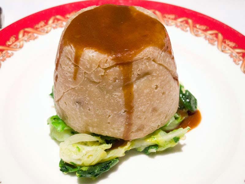 Steak and Kidney Pudding from Rules, London's oldest restaurant in Covent Garden. Diced steak, onion, and kidney (lamb or pig kidneys) in gravy, wrapped in suet pastry and steamed. Considered one of Britain's national dishes.