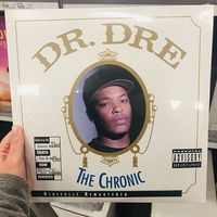 April 11, 2019 - Minneapolis, MN: Female Caucasian hand holds up a Dr. Dre The Chronic vinyl record album while shopping in a retail store, a classic retro 90s gangster rap album