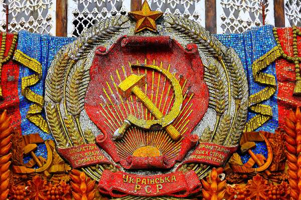 Communism - mosaic hammer and sickle with star on the Pavilion of Ukraine at the All Russia Exhibition Centre (also known as VDNKh) in Moscow. Communist symbol of the former Soviet Union. USSR