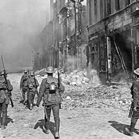 A British North Lancashire Regiment patrol a street in the southern part of Cambrai, France, October 9, 1918.