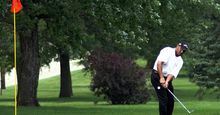 Golf. Putt. Putter. Sports. Pro tournament golfer pitching on the green with the pin in the hole.