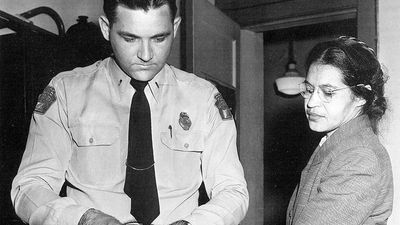 Rosa Parks 1913-2005, whose refusal to move to the back of a bus touched off the bus boycott in Montgomery, Alabama. Fingerprinting Parks is Deputy Sheriff D .H. Lackey. December 1, 1955.