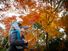 Father and daughter looking at autumn leaves