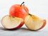 Slices of ripe apples on a wooden table