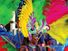 A woman with a brightly-colored feather headdress and costume, during a Carnival parade in Rio de Janeiro. Rio Carnival. Brazil Carnival.