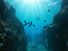 Small canyon underwater carved by the swell into the fore reef with sunlight through water surface, Huahine island, Pacific ocean, French Polynesia.