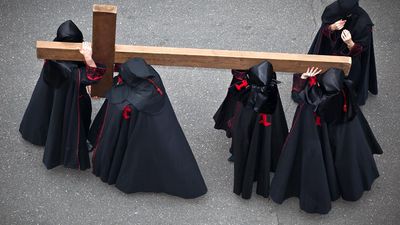 Holy week. Easter. Valladolid. Procession of Nazarenos carry a cross during the Semana Santa (Holy week before Easter) in Valladolid, Spain. Good Friday