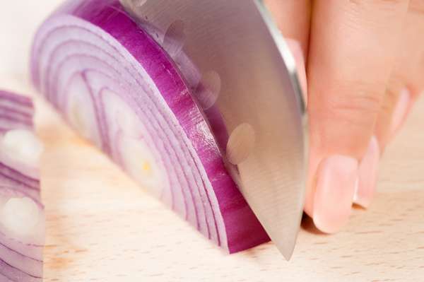 Women cutting and onion, cooking, vegetables