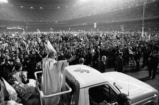 Pope John Paul II in an open-air Popemobile