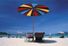 Deck chairs under a beach umbrella.