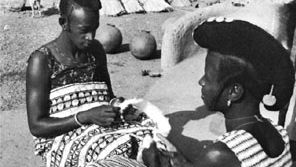 Hausa women preparing cotton to be made into cloth