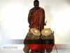 Observe a man playing the atumpan, a talking drum of the Asante people of West Africa