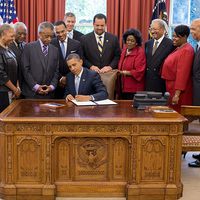 President Barack Obama signs the White House Initiative on Educational Excellence for African Americans Executive Order in the Oval Office, July 26, 2012