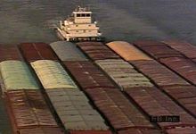 Behold a barge-carrying ship transporting a load down the Mississippi River