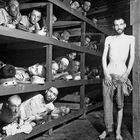 Prisoners of Buchenwald concentration camp, near Weimar, Germany, April 16, 1945, liberated by American troops of the 80th Division. Elie Wiesel (7th from the left on the middle bunk next to the vertical post) World War II Holocaust