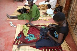 Women working with beads to create jewelry, Juba, South Sudan.