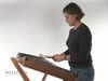 Watch a woman playing the hammered dulcimer