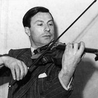 Undated photograph of American violinist Nathan Milstein playing a 1716 Stradivarius violin. Undated photo.