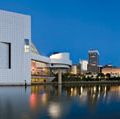 Downtown Cleveland after sunset. Rock and Roll Hall of Fame and Museum (left). Museum and hall of fame in Cleveland that celebrates the history and cultural significance of rock music