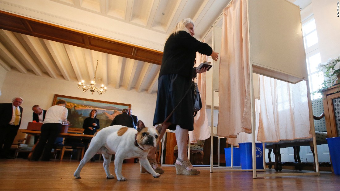 A woman enters a voting booth in Saint Jean de Luz, France, Sunday, May 7.