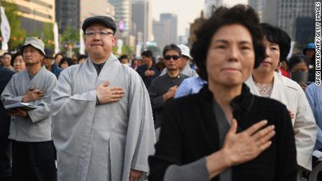 Buddhist followers pray for the success of the inter-Korean summit, in Seoul on April 27, 2018. - The leader of nuclear-armed North Korea Kim Jong Un and the South&#39;s President Moon Jae-in said they were committed to the denuclearisation of the Korean peninsula after a historic summit on April 27. (Photo by GREG BAKER / AFP)        (Photo credit should read GREG BAKER/AFP/Getty Images)